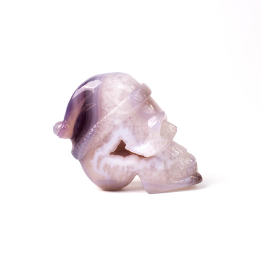 Natural agate crystal cave skull with Christmas hat, hand carved, ornament, collectible